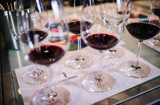 White Tasting Mat with Red Wine in Glasses Set Up for a Wine Tasting