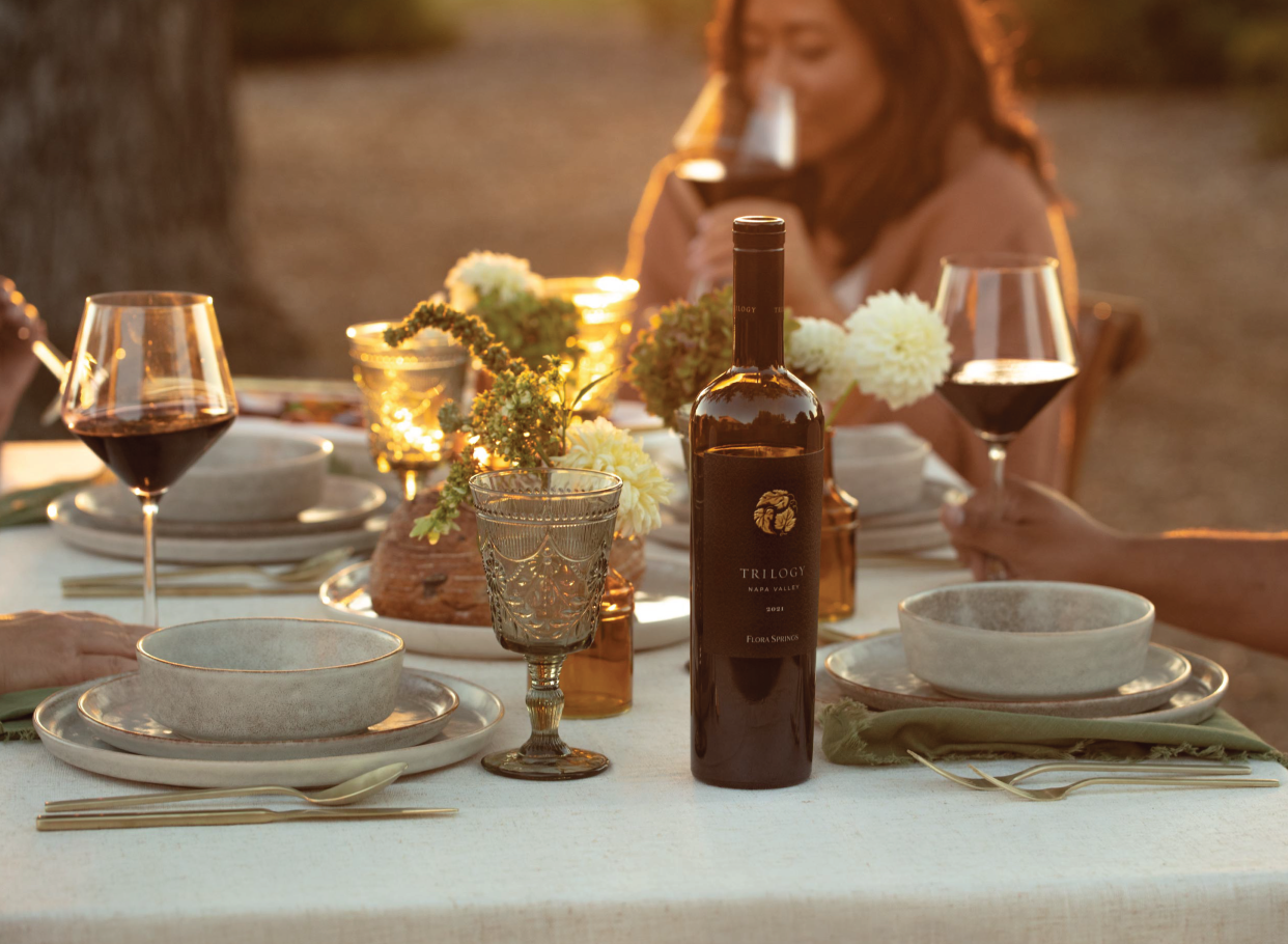 People enjoying glasses of 2021 Flora Springs Trilogy Wine.