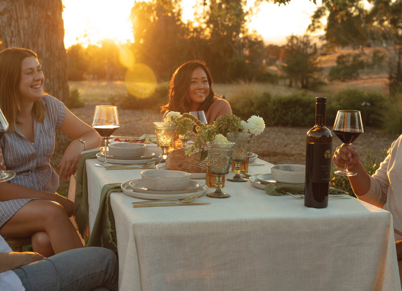 People gathered around a table enjoying Flora Springs wine.