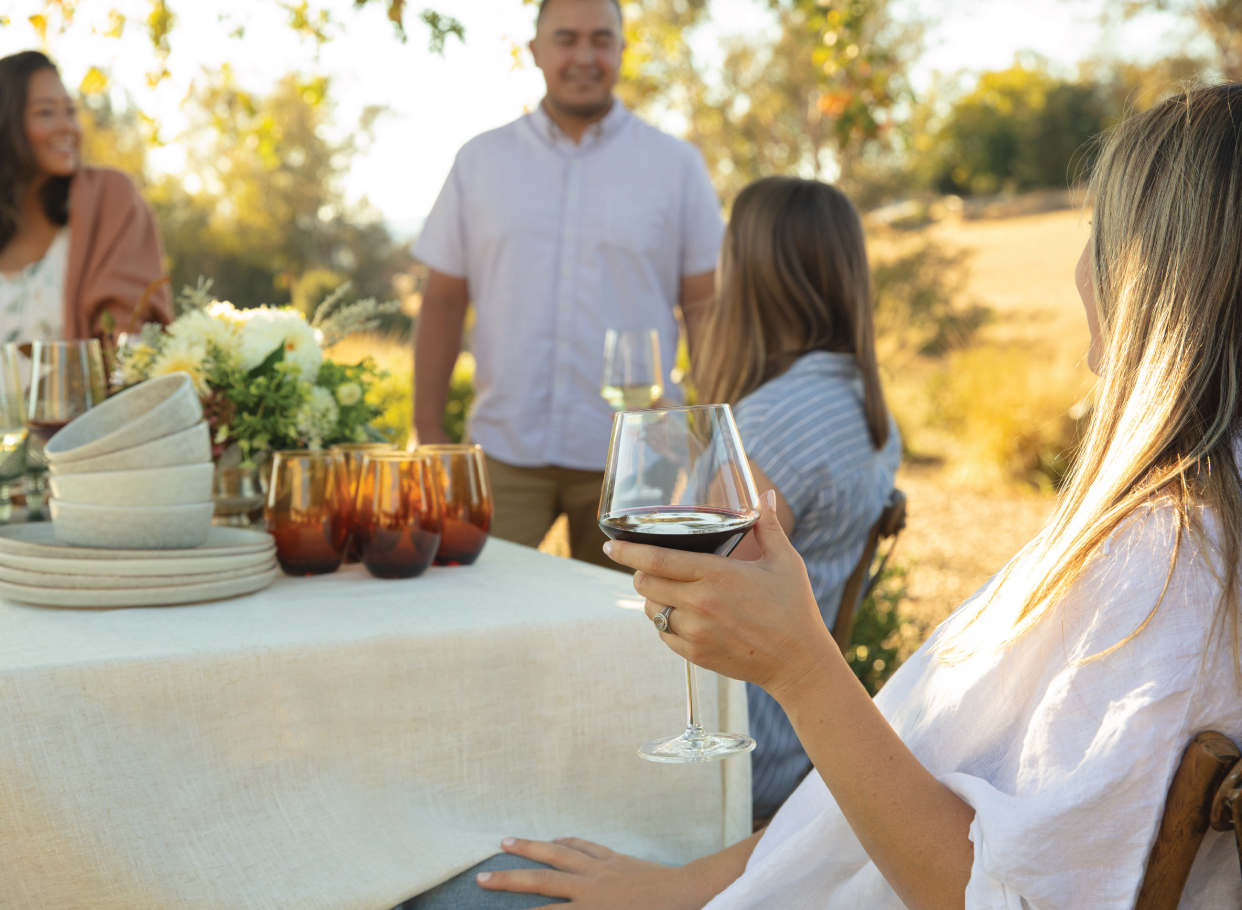 People gathered around a table enjoying Flora Springs wine.