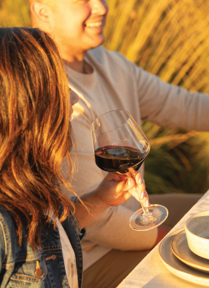 Woman holding wine glass full of Flora Springs Wine.